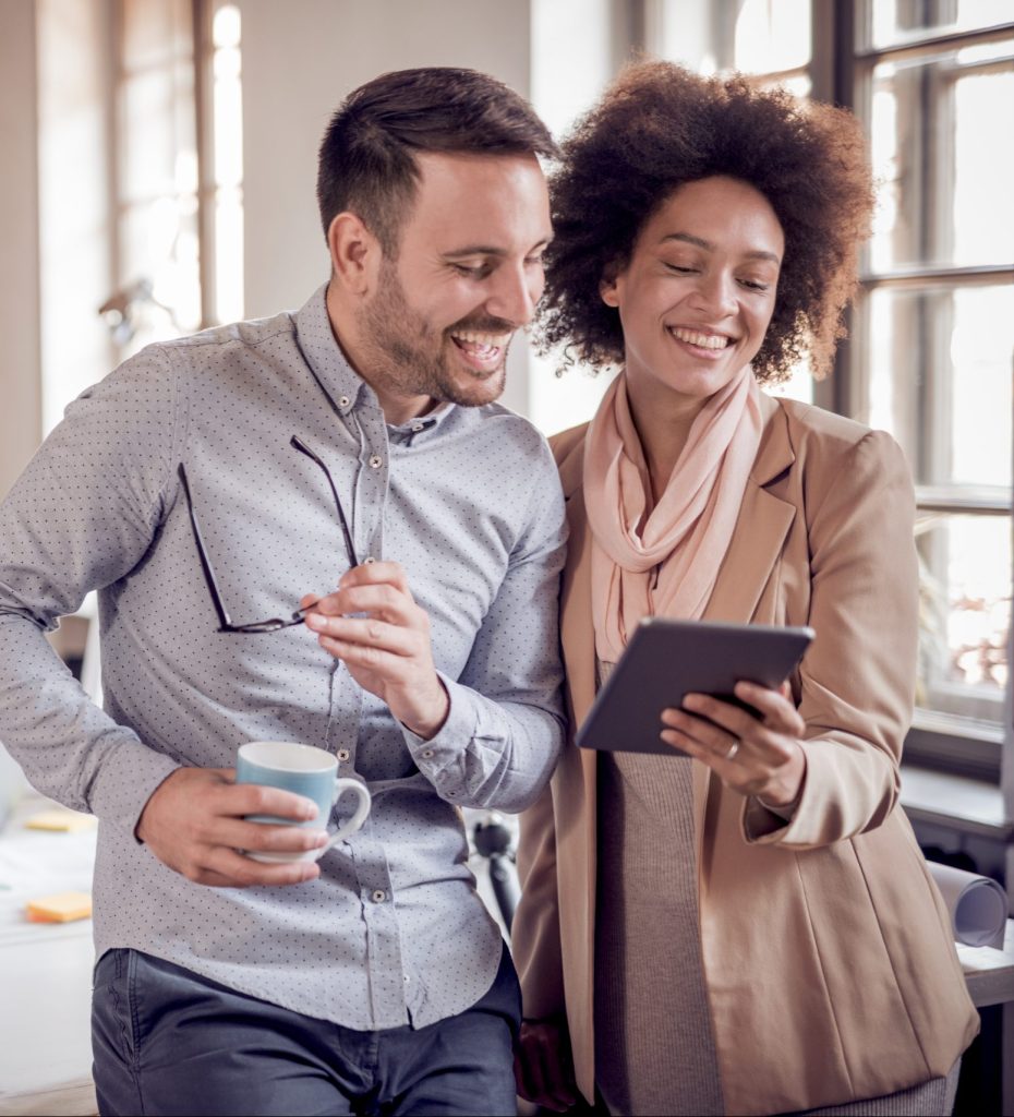 TurnoutNow Business colleagues in modern office using tablet